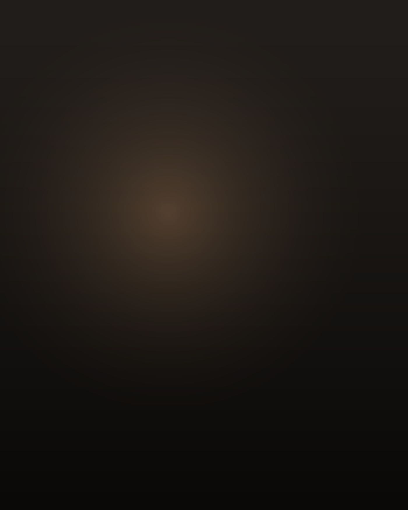 A Filipino American man in his late fifties, heavyset and thick through the chest and shoulders with a heavy belly, short greying hair, wearing pale blue scrubs, standing alone in a dim care-home corridor at night, seen from behind and slightly to the side so his face is not visible; the only light is a low nightlight near the floor and the warm glow from one open doorway, everything else in deep shadow.