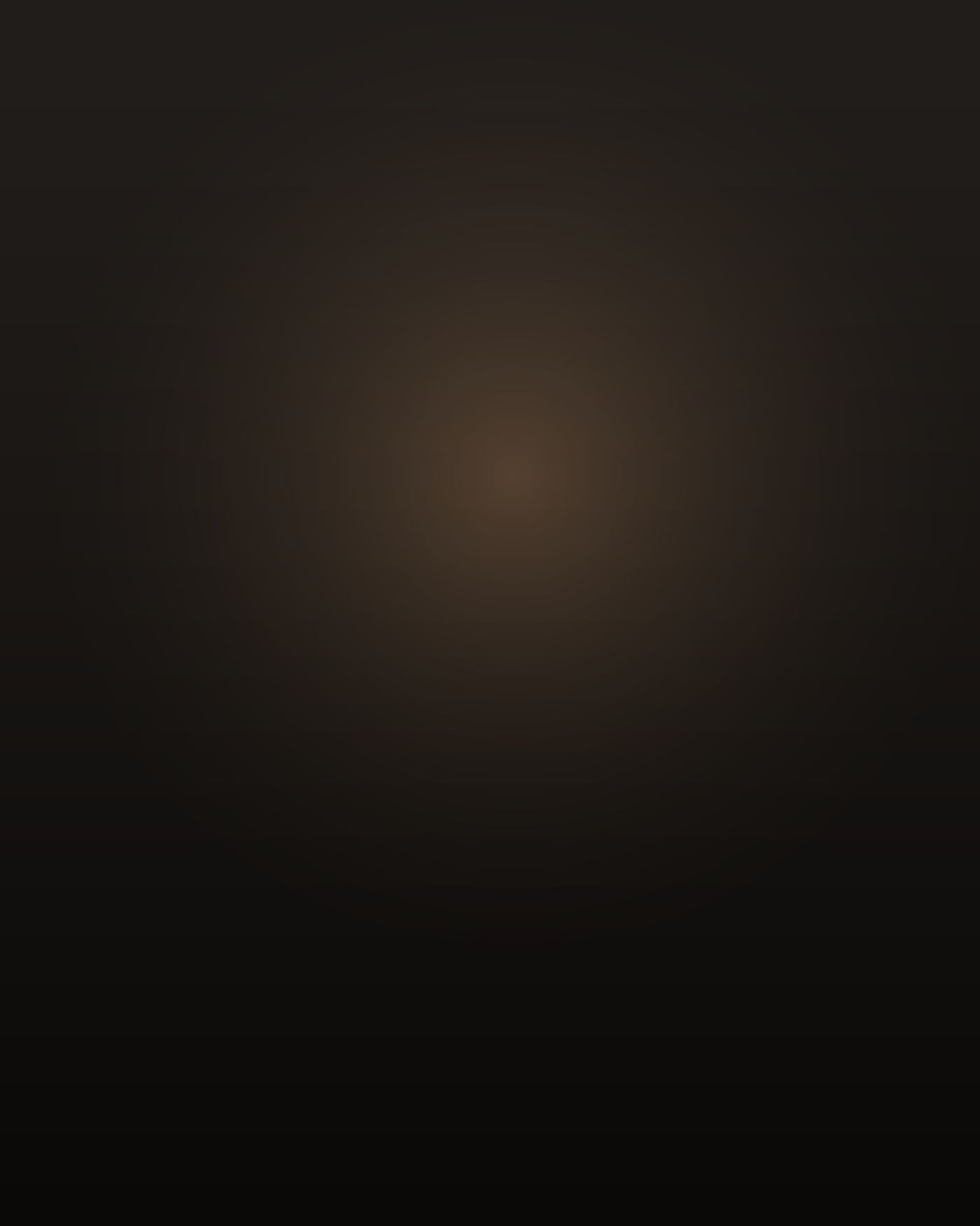 A short, slight Vietnamese man of about nineteen, thin build, black hair flat on his forehead, standing in profile in a narrow dim hallway holding a green plastic cup, warm lamp light spilling from a bedroom doorway ahead of him, most of his body in deep shadow, not facing the camera.