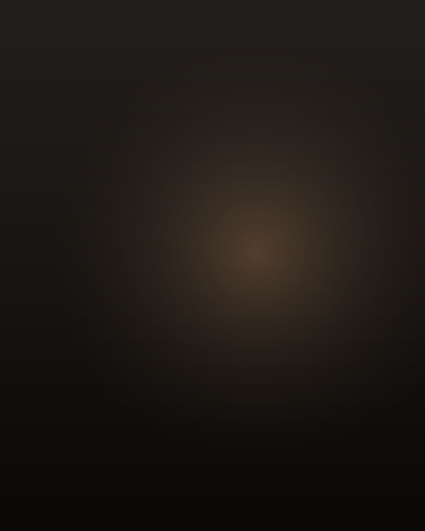 A heavyset Black man in his mid-thirties, thick through the chest and belly with a close-cropped fade and a short beard, standing on the step of a sleeper cab at night with one hand on the grab bar, seen from behind and slightly to the side, face turned away toward the dark of a truck yard, lit low and warm by the dash glow and one sodium lamp across the lot, deep shadow everywhere else.