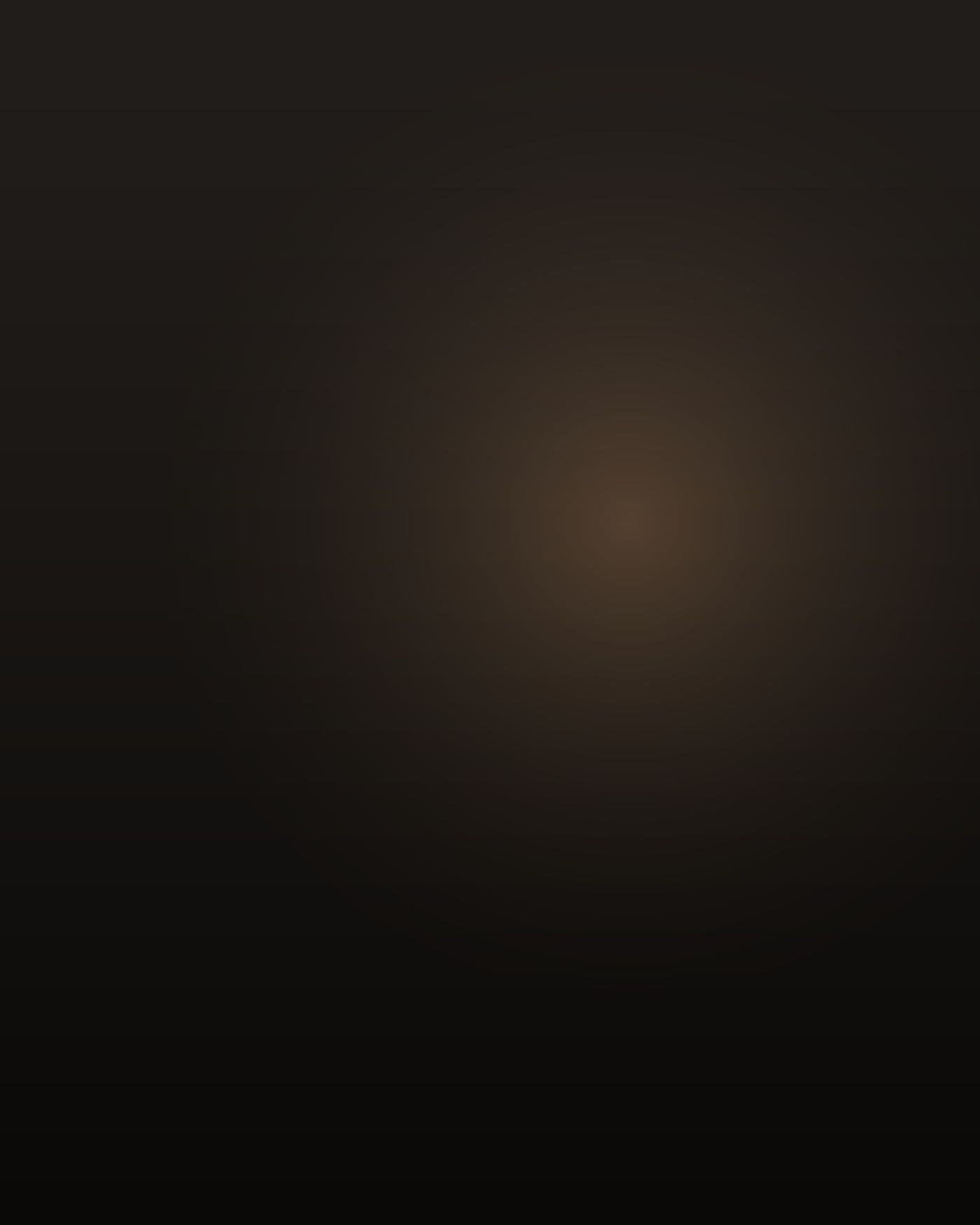One man alone, Lebanese, early sixties, brown skin, grey moustache and thinning grey hair, heavy-framed but gone loose through the middle after losing weight, in a zip-up windbreaker and white walking shoes, photographed from behind and slightly to the side in a dim empty shopping mall concourse before opening hours, low warm light from a skylight, deep shadow, not facing the camera.